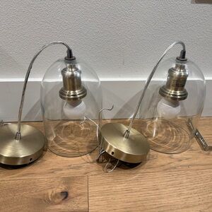 Set of Two CB2 Glass Pendant Lights with Brass Accents